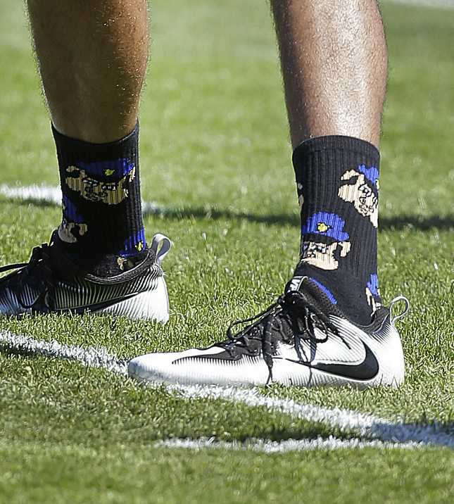 San Francisco 49ers quarterback Colin Kaepernick wears socks that appear to disrespect the police during a practice Wednesday, Aug. 10, 2016, at Kezar Stadium in San Francisco. (AP Photo/Ben Margot)
