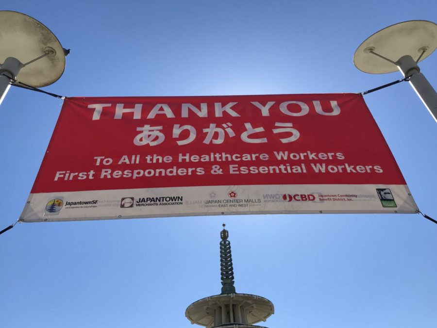 At the entrance of the Japantown Peace Plaza, a banner thanks healthcare workers, first responders, and essential workers in both English and Japanese.