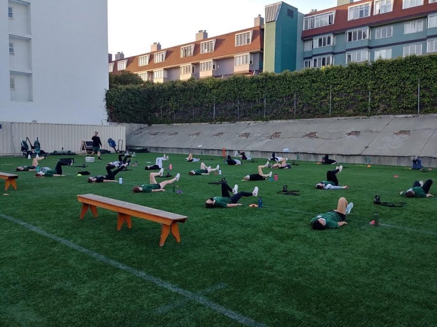 The Girls Tennis team goes through a socially distanced cool-down stretch after working out in a physically-distanced pod.