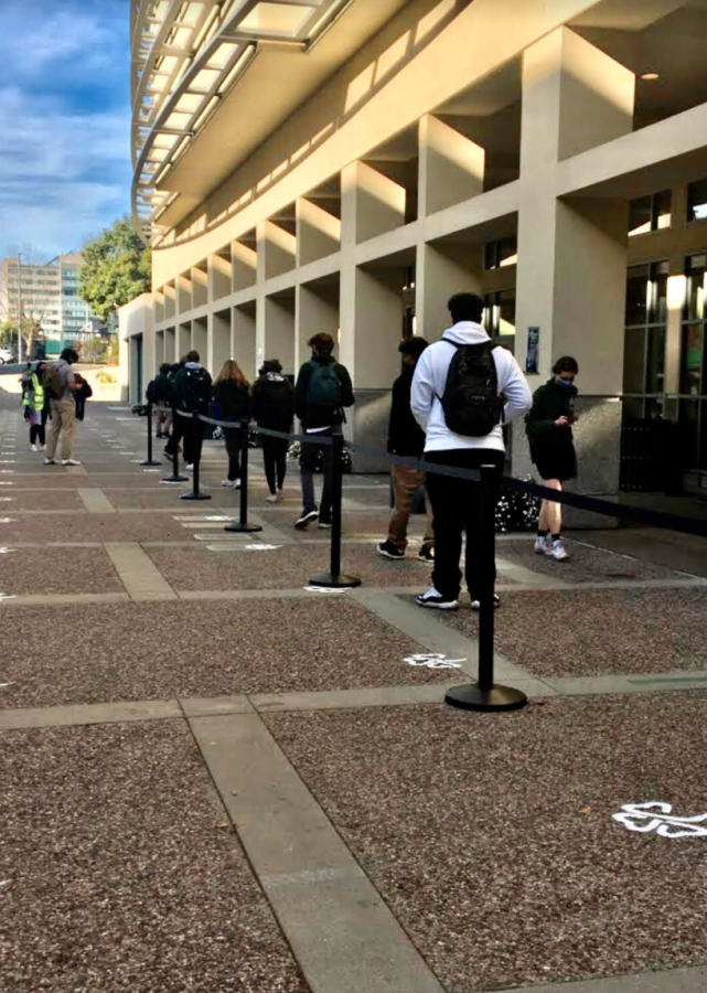 Students wait in line for grab and go lunches.