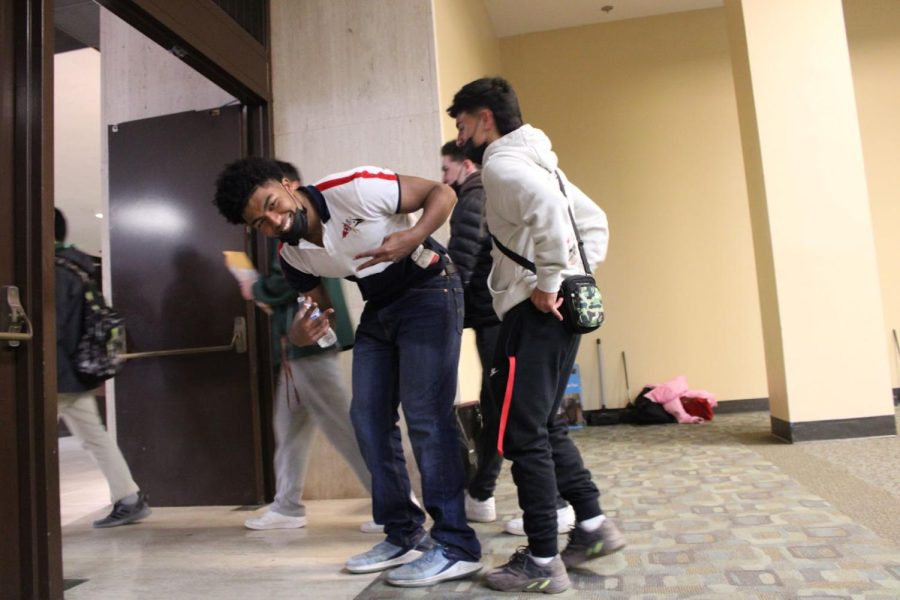 Senior Silas Bahlibi poses for the camera after getting to school early to help set up for the retreat.