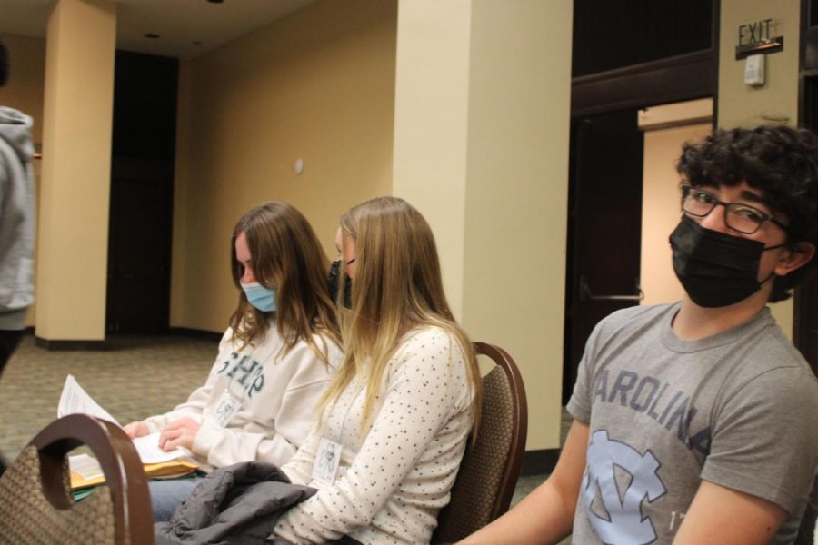 Senior Fiona Deasy and sophomores Katherine Borek and Wyatt Rici get ready for mass.