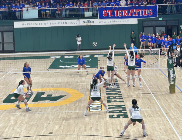 #11, Sarah Chow ‘24, reaches for the ball while her teammates block the Wildcats at the net.