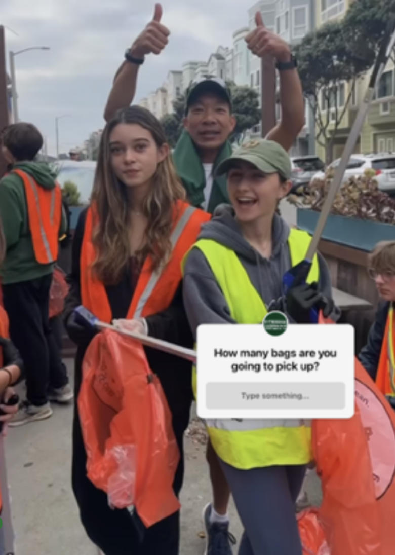 Coach Andy Chan, Ciarra McGarry '24, and Bridget Panina '24 pose for a photo picking up trash with the rest of the Cross Country team. 