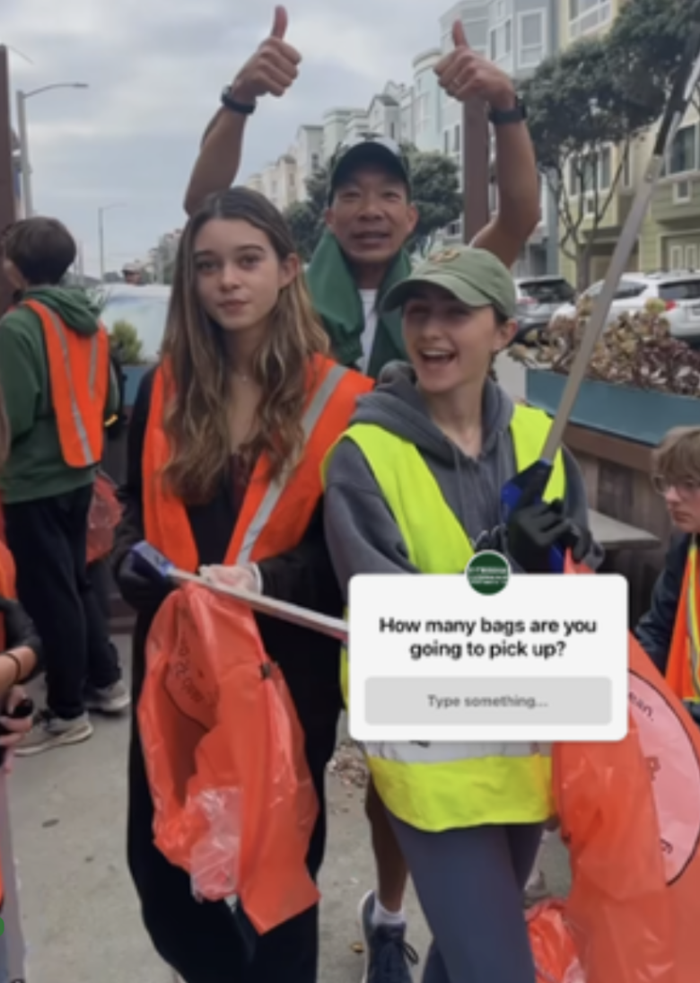 Coach Andy Chan, Ciarra McGarry 24, and Bridget Panina 24 pose for a photo picking up trash with the rest of the Cross Country team. 