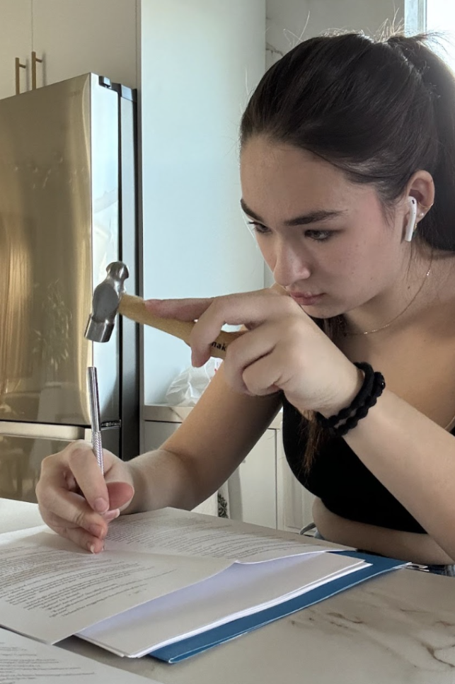 Allie Haahr '24 works on the bindings for one of her January Project books.