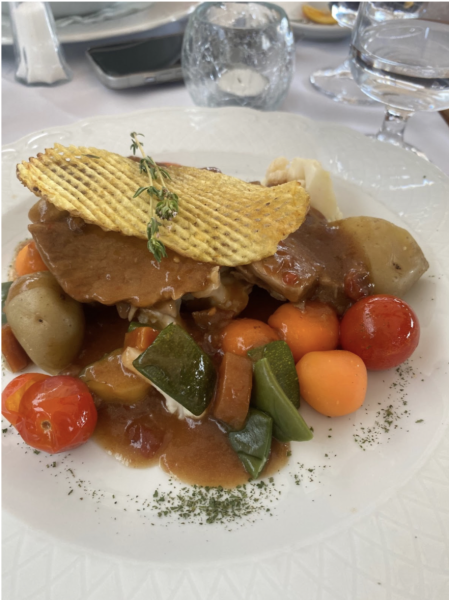 A well-plated dish of leg of lamb, served with vegetables (left) and a delicious fine filleted pork tenderloin with a mustard sauce and plums.