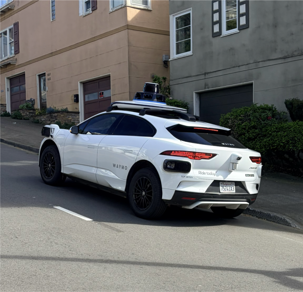 Waymo stopped in front of a home waiting for its passengers on 17th St. in San Francisco. 